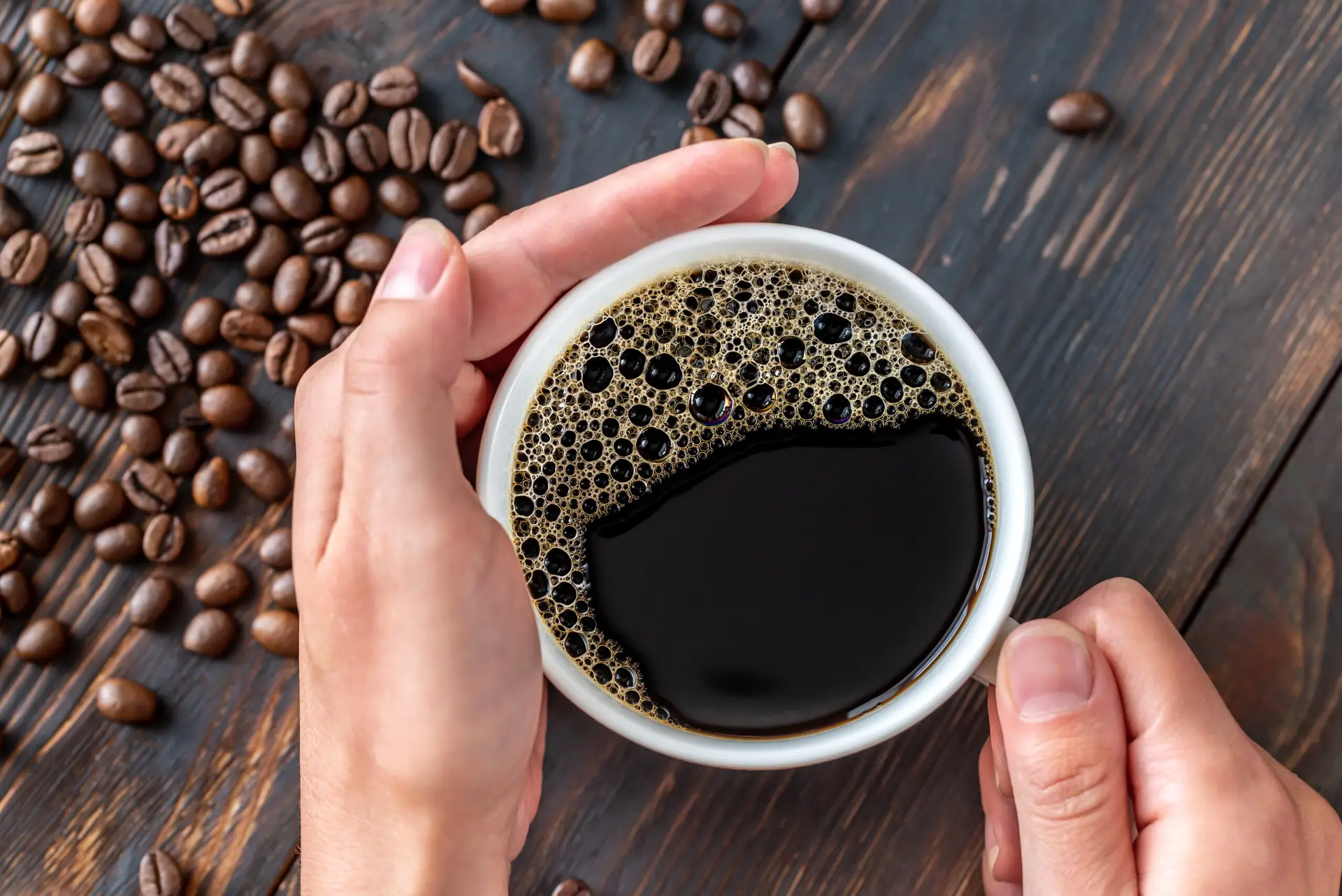 Woman's hands holding a cup of coffee